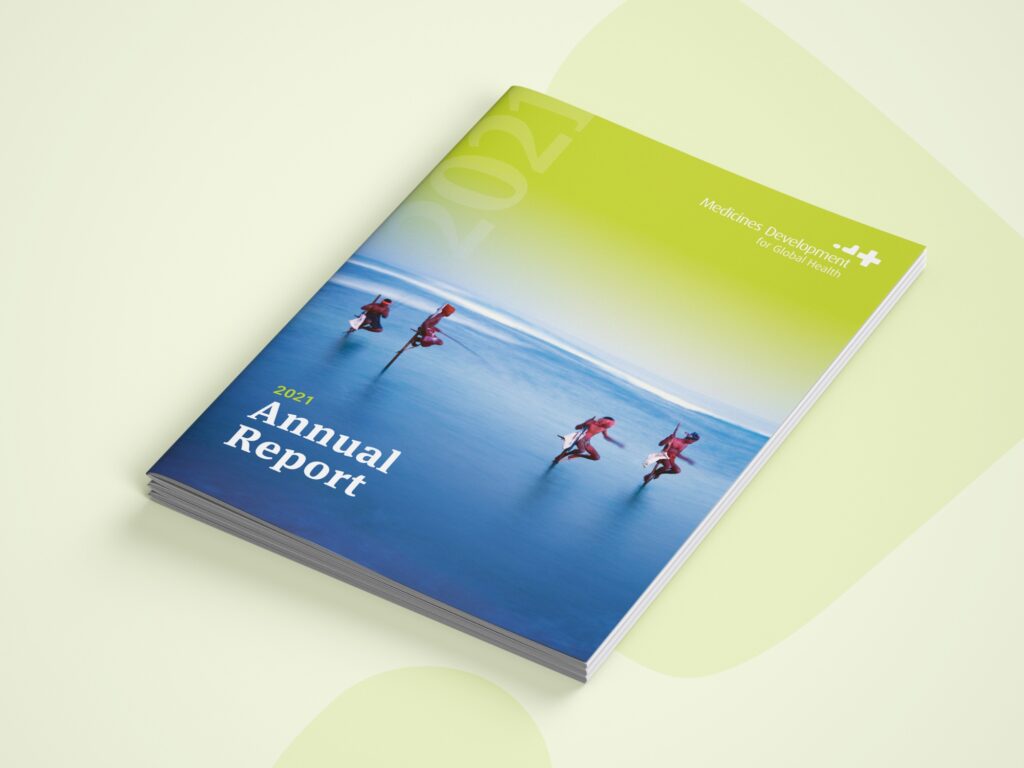 Annual report booklet cover with athletes in blue water, printed on recycled paper