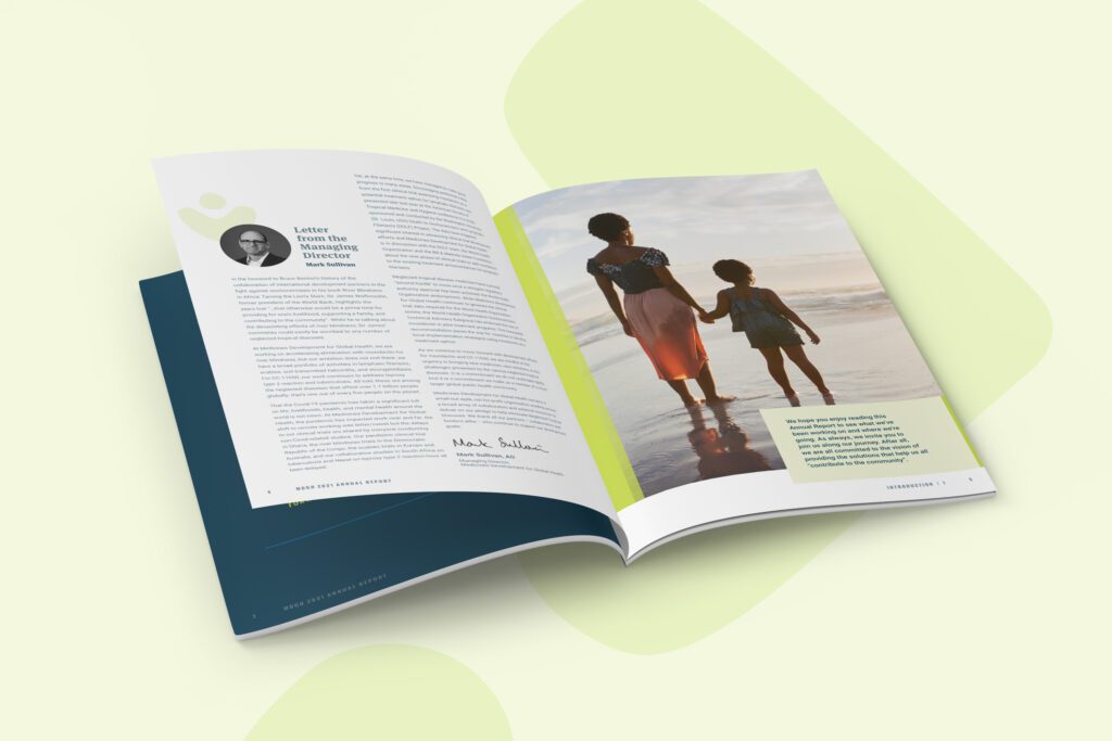 Inside spread of the 2021 Annual report displaying a letter from the Managing Director of Medicines Development for Global Health on the left page and an image of a woman and child walking on the beach on the right page, against a soft green background.
