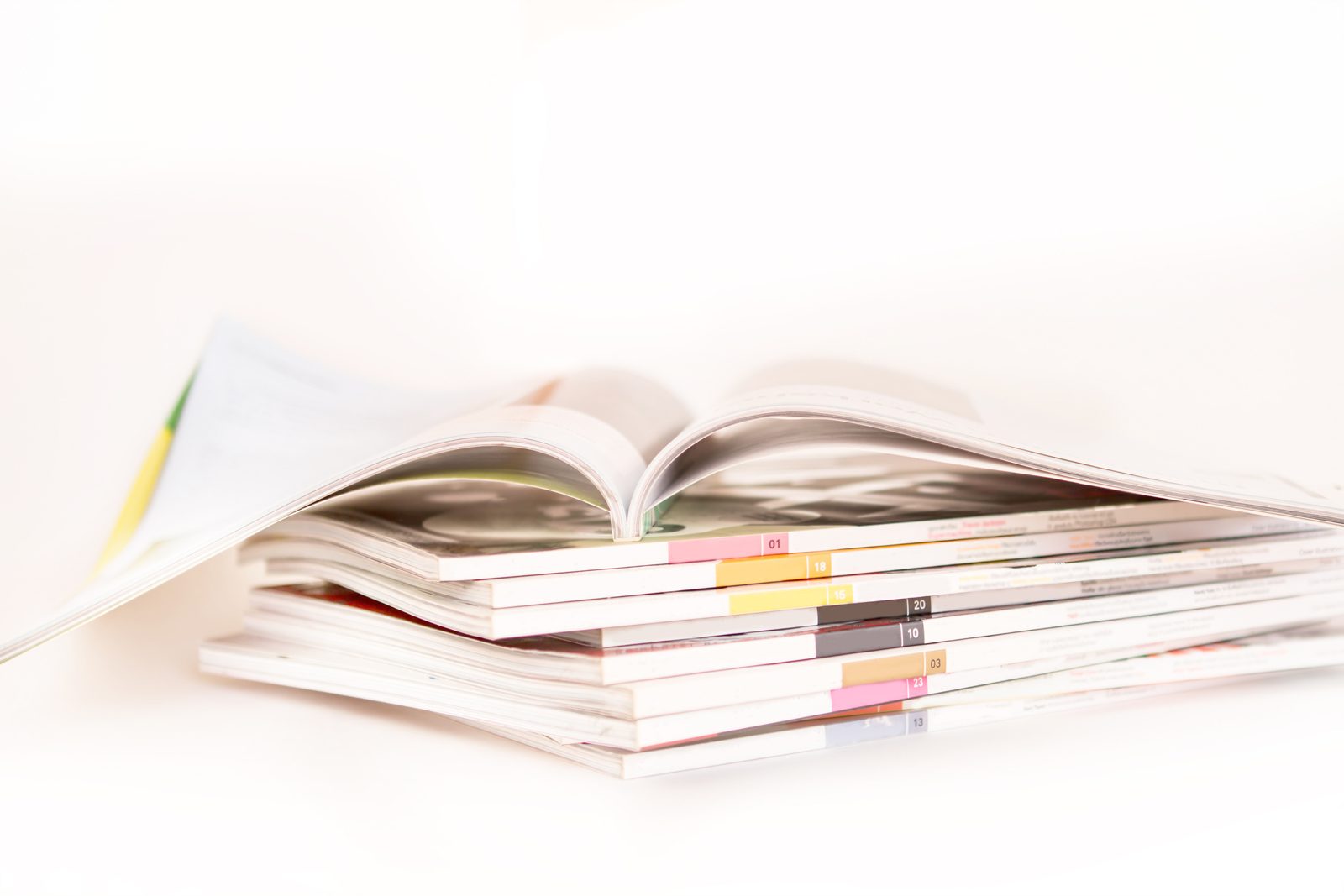 Perfect bound booklets with a flat glued spine, compared with saddle stitch